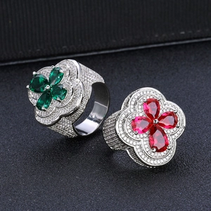 Luxurious iced out flower rings with red and green gems and sparkling zircon stones