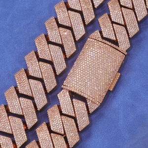 Macro detail of rose gold Cuban link bracelet with pavé cubic zirconia on blue background