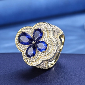 Luxurious gold plated flower ring with pear-cut blue stones and white zircon crystals