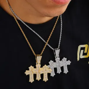 Detail of hip hop iced out gold and silver cross pendants with zircon on rope chains