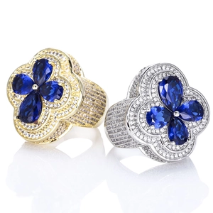 Detail of luxury clover rings in gold and silver with blue stones and pave setting
