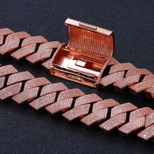 Macro detail of rose gold iced out Cuban link chain with pave set crystals and clasp