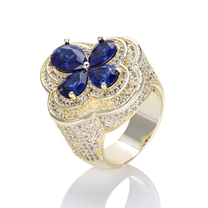 Macro shot of blue flower ring with four pear-cut stones and pave-set zircons