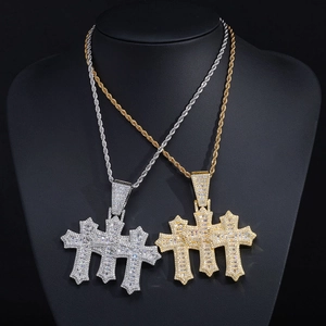 Detailed macro view of triple cross pendant with clear cubic zirconia in hip hop style