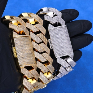Close-up of gold and silver cuban link bracelets with full micro-pave cubic zirconia diamonds