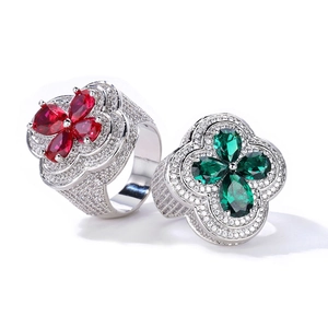 Detail of clover rings with ruby and emerald pear-cut stones and pave-set white zircons