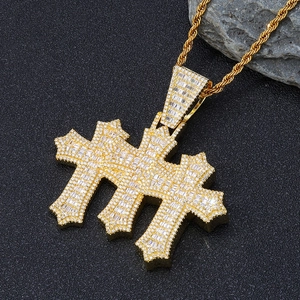 Macro shot of gold cross pendant featuring baguette-cut and round cubic zirconia stones