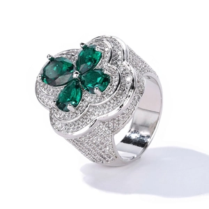 Macro side view of clover ring with green gemstones and white zircon micro-pave setting