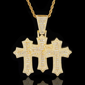 Detailed view of triple-layered cross pendant with baguette-cut zircons on a gold rope chain