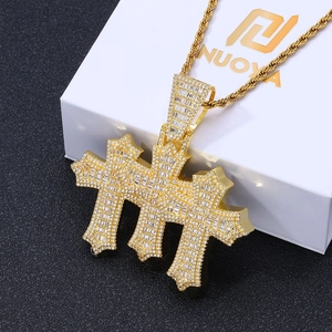 Close-up of hip hop gold cross pendant with cubic zirconia on a gold rope chain