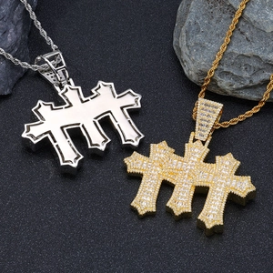 Macro detail of gold and silver hip hop cross pendants with rope chains and inlaid zircons