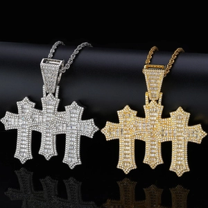 Close-up of gold and silver hip hop cross pendants with baguette-cut cubic zirconia