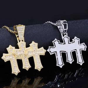 Detailed view of hip hop triple cross pendants with gold plating and cubic zirconia