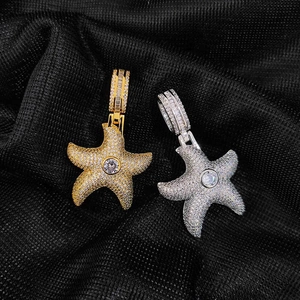 Macro shot of gold and silver hip hop starfish pendants with cubic zirconia micro-pave setting