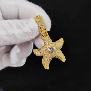 Macro shot of hip hop starfish pendant with iced out gold plating and sparkling zircons