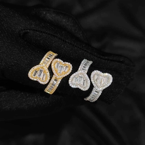 Detail view of gold and silver iced out rings with baguette and round cut zircons