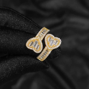Gold double heart ring with baguette and round cubic zirconia in a mixed setting style