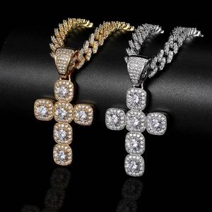 Détail de pendentifs croix hip hop or et argent avec maillons cubains sertis de zircon