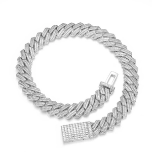 Macro detail of iced out silver Cuban link chain with baguette and round zircons