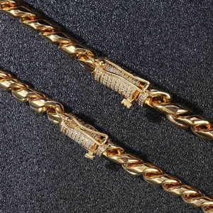 Golden hip hop Cuban link necklace featuring a diamond-encrusted box clasp on black background