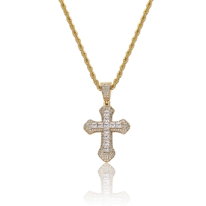 Détail du pendentif croix dorée serti de zircons et chaîne corde style hip hop