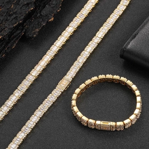 Macro view of gold hip-hop jewelry set with baguette cut cubic zirconia stones
