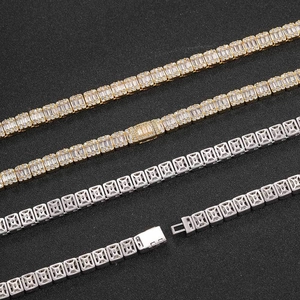 Macro detail of 8mm gold and silver tennis bracelets with baguette cut cubic zirconia