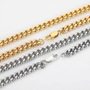 Detailed close-up of gold and silver cuban link chains featuring secure lobster clasps