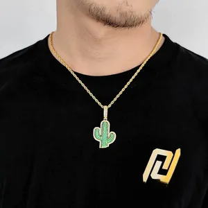 Close-up of hip hop gold twist chain and cactus pendant with green micro-pave zircons