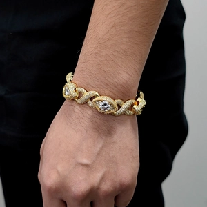 Close-up of gold iced out infinity eye link hip hop bracelet with white zircon stones