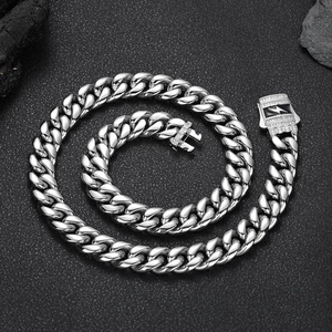 Chunky stainless steel Cuban link necklace with lightning bolt zircon clasp on dark rock