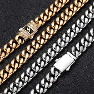 Macro detail of lightning bolt zircon clasps on heavy stainless steel Cuban chain necklaces