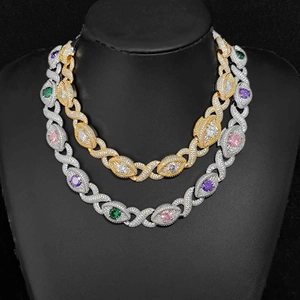 Detail of hip hop Cuban chain with multicolored zircon stones on black bust display