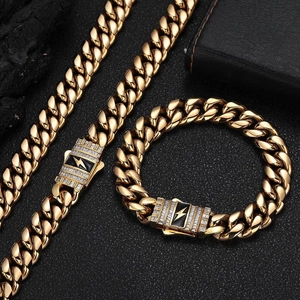 Close-up of golden Cuban link necklace and bracelet set with lightning bolt zircon clasp