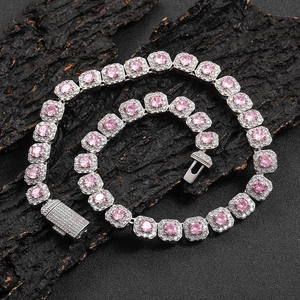 Close-up of pink zircon hip hop tennis necklace with sparkling box clasp on dark background