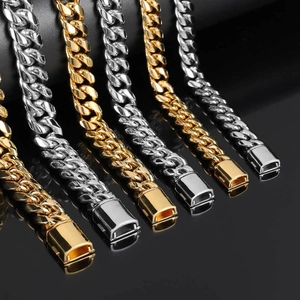 Macro detail of high-polish stainless steel Cuban link chains with rectangular box clasps