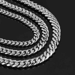Detailed close-up showing three different widths of stainless steel Cuban link chains