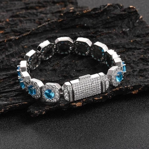 Luxurious 12mm silver-tone hip hop bracelet with blue zircon stones on dark wood background
