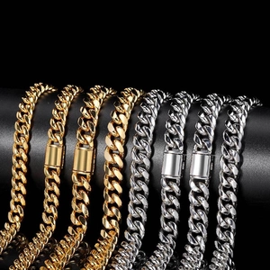Detailed close-up of gold and silver cuban link chains displayed on a black podium