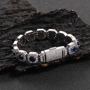 Detailed close-up of luxury hip hop chain bracelet with blue zircon and pavé setting