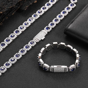 Detail of luxury silver cuban chain with deep blue zircon stones and white crystal halo