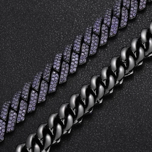 Macro detail of gun black Cuban chain with purple zircon pavé and polished metal links