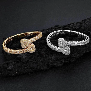 Iced out heart open bracelet with gold and silver finish featuring AAA cubic zirconia
