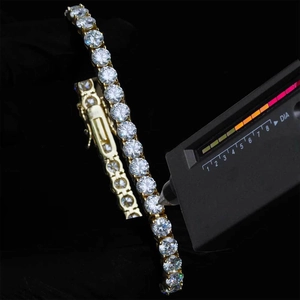 Close-up of diamond tester tool checking high hardness moissanite on silver tennis bracelet