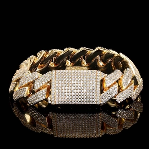 18mm Cuban link bracelet in gold finish with triple-row diamonds on black background