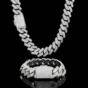 Detailed macro shot of 18mm silver Cuban link necklace and bracelet with zircon inlay