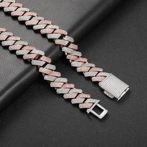 Detailed close-up of iced out two-tone Cuban link chain with micro-pave crystals