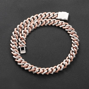 Detail of two-tone Cuban link chain with silver and rose gold polished metal finish