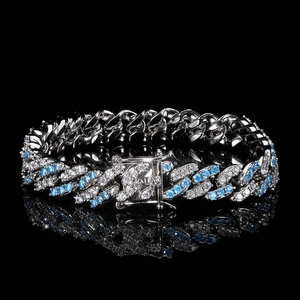 Detailed macro view of 9mm Cuban link anklet with blue and white zircon stones