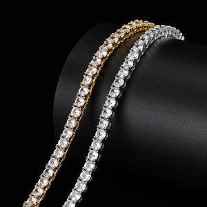 Macro detail of gold and silver tennis bracelets with cubic zirconia on black display